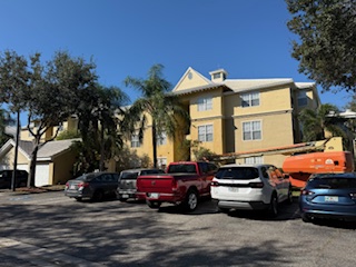 Boom lift pressure washing multi-story building Sarasota FL