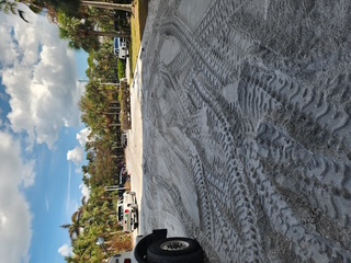 Parking lot sand and debris before pressure washing — Sarasota FL